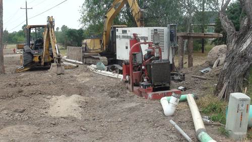 Shoring and dewatering of excavated trench to install sanitary sewer line and manhole, La Feria, TX