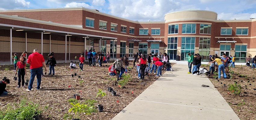 Students landscaping in front of school