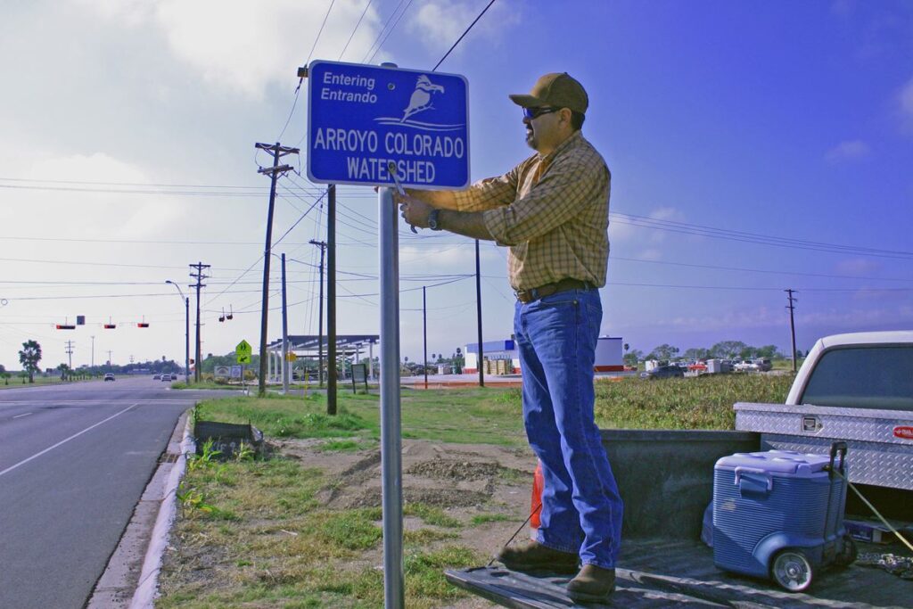 Watershed Coordinator Jaime Flores installing an Arroyo Colorado Watershed Boundary sign, AgriLife Today