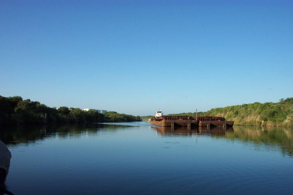 Barge moving through the tidal segment of the Arroyo Colorado