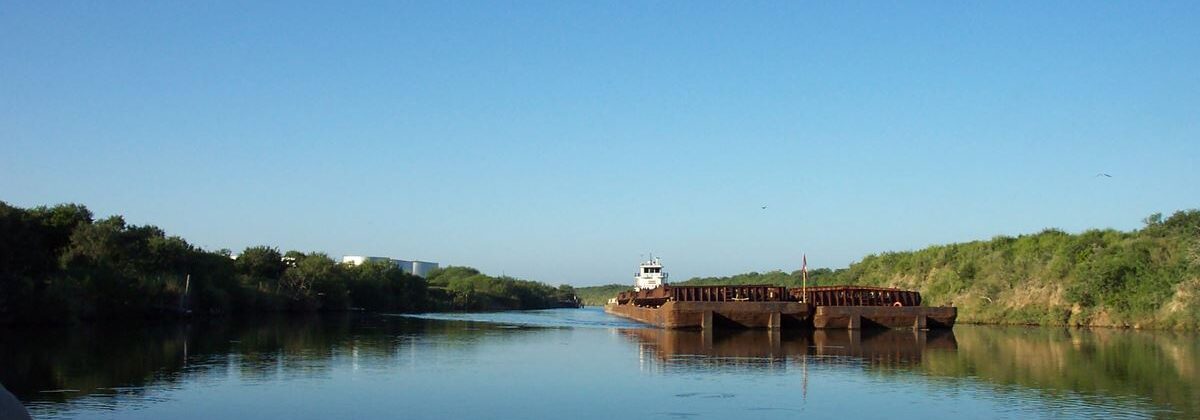 Barge moving through the tidal segment of the Arroyo Colorado