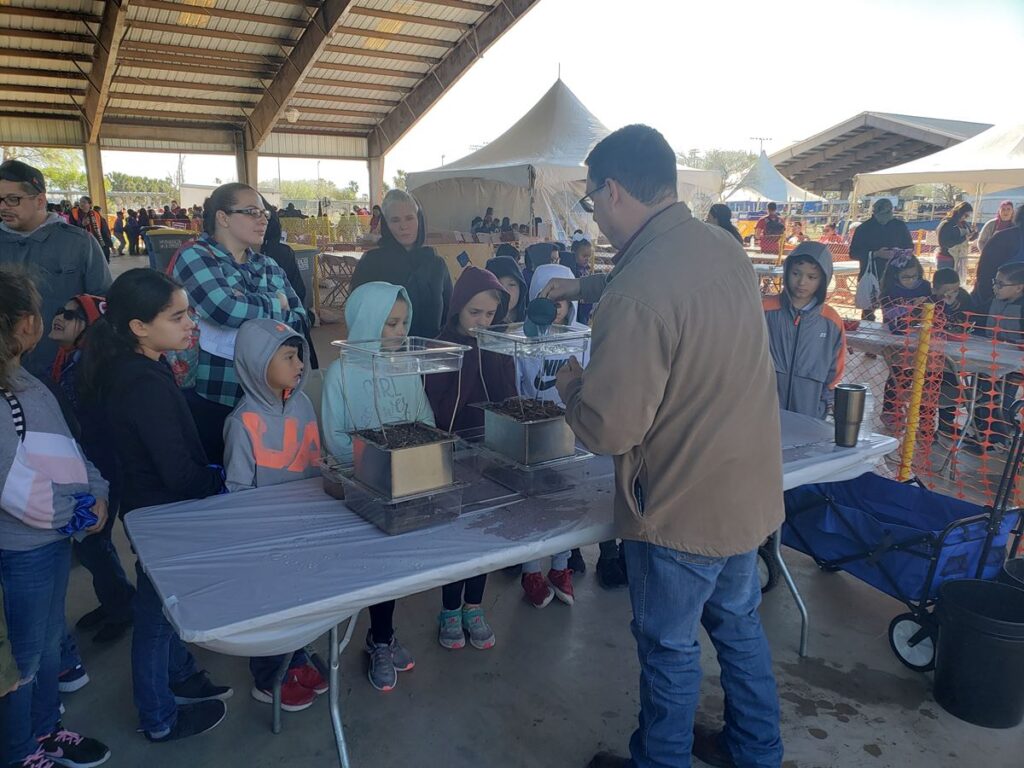 Victor Gutierrez, AgriLife Extension Associate, at the 2020 Coastal Expo, explaining the rainfall simulator and erosion and run-off.