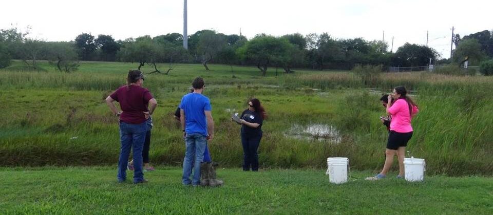 High school students collecting water samples to test the water