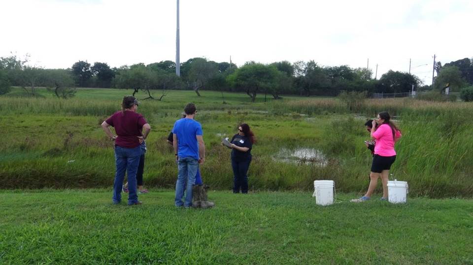 High school students collecting water samples to test the water