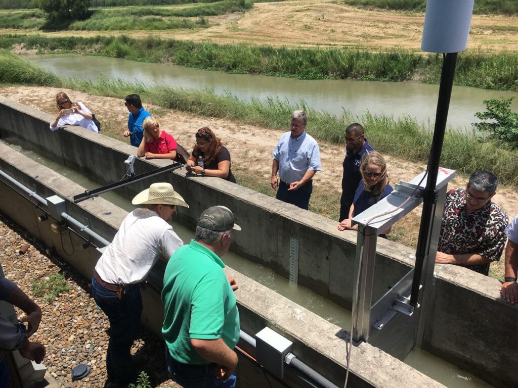 Tom McLemore, general manager, Harlingen Irrigation District, discusses the components and utility of the automated canal gate demonstration channel at the Rio Grande Center for Ag Water Efficiency.