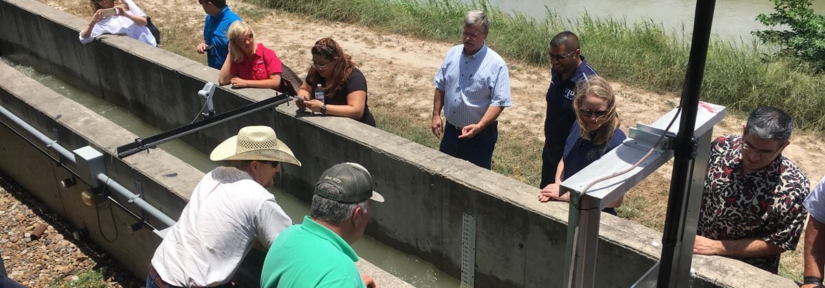 Tom McLemore, general manager, Harlingen Irrigation District, discusses the components and utility of the automated canal gate demonstration channel at the Rio Grande Center for Ag Water Efficiency.
